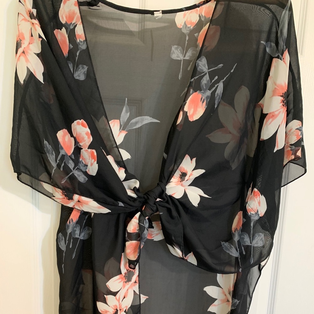 Sheer kimono with bright pink flowers.